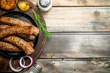 Grill sausages with spices and herbs .