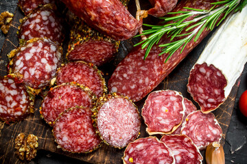 Different types of smoked salami with aromatic seasonings.