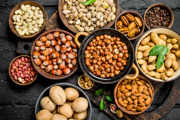 Assortment of different nuts in bowls.