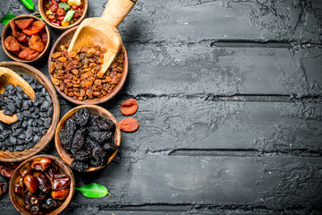 Assortment of different types of dried fruits in bowls.