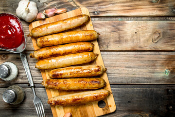 Grill sausages with tomato sauce.