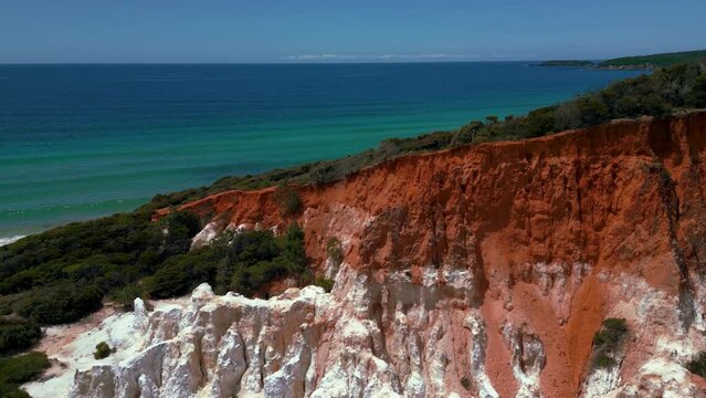 Red rock Pinnacles at Beowa and Ben Boyd National Park, New South Wales, Australia, near Sydney. Drone aerial view with seaside sandy clear water beach in 4K UHD. Tourist attraction nature documentary