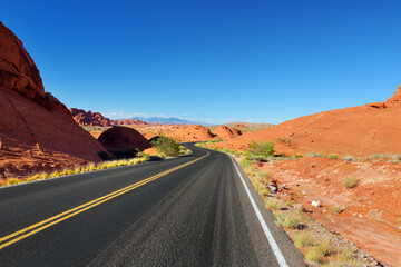 Fototapeta na wymiar A road leading through sandstone formations in Valley of Fire State Park, Nevada, USA.