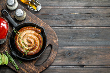 Fried sausages with sauce and aromatic herbs.