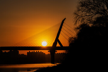 Fototapeta na wymiar Sunrise over the suspension bridge