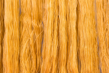 Dye orange color cotton thread background, textile industry concept, product of Thailand