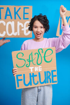 Teenage activist protesting with save the future sign