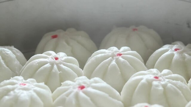 Close-up steamed stuff buns with steam in a steaming pot. Chinese food