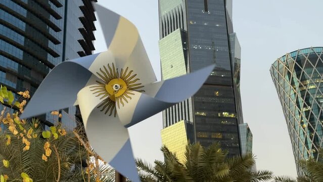 Argentina final FIFA world cup Qatar champion in football international scenic tournament in stadium with Messi player and city landscape design on flag printed on whirligig decoration design