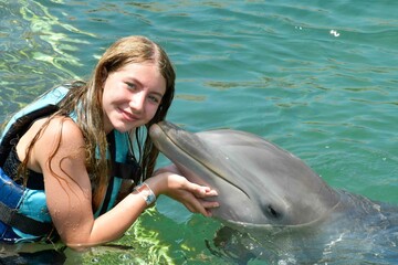 Girl kissing dolphin © Laurie