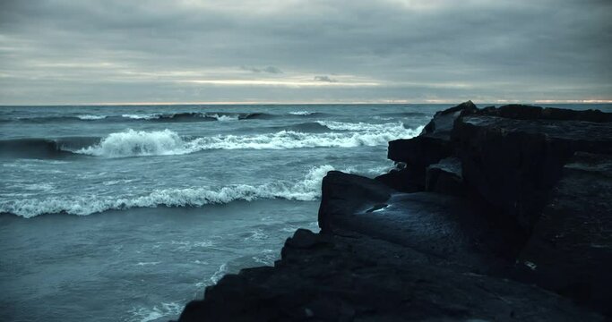 Powerful Iceland Storm Waves Crashing against Black Beach Rock Cliffs. Incoming Arctic Tide Ocean Sea Water Surge Splashing on Large Boulders 4k