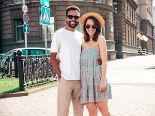 Smiling beautiful woman and her handsome boyfriend. Woman in casual summer clothes. Happy cheerful family. Female having fun. Sexy couple posing in the street at sunny day. In hat and sunglasses