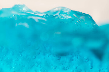 fake wave, selective focus small bubble floating in blue gel like under the ocean.