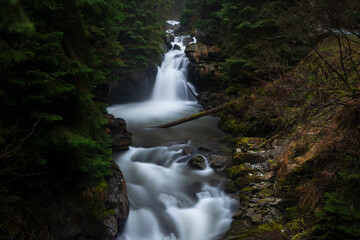 Sucu waterfall flowing through rocks in a deep forest