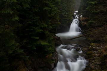 Sucu waterfall flowing through rocks in a deep forest - 562027479