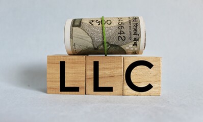 Limited liability company. LLC the word on wooden cubes, cubes are on a white background. Business...