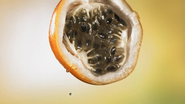 Slow Motion Macro Shot of Flowing Granadilla Juice from Halved Granadilla