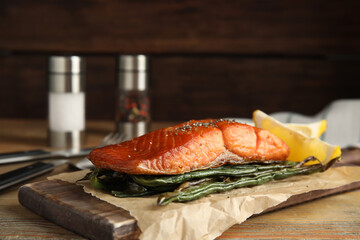 Tasty cooked salmon and vegetables served on wooden table. Healthy meals from air fryer