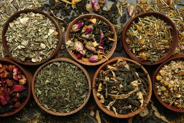 Flat lay composition with different dry teas on table