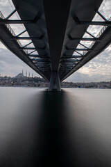 Long exposure. View of Haliç Metro Bridge connecting Azapkapı (Beyoğlu) and Unkapanı (Fatih) (Halic Metro Bridge). blue sky Istanbul Turkey	