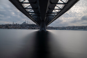 Long exposure. View of Haliç Metro Bridge connecting Azapkapı (Beyoğlu) and Unkapanı (Fatih) (Halic Metro Bridge). blue sky Istanbul Turkey	