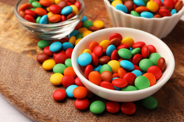 Tasty colorful candies on wooden table, closeup
