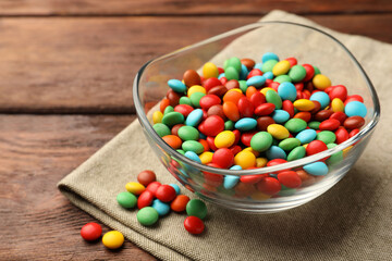 Tasty colorful candies on wooden table, closeup