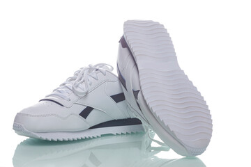 Two White Pieces of Footwear as Pair of New White Sneakers Placed Against White Background.
