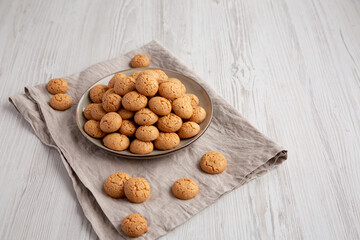 Homemade Italian Amaretti Cookie Biscuits on a Plate, side view. Space for text.