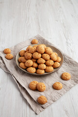 Homemade Italian Amaretti Cookie Biscuits on a Plate, side view.