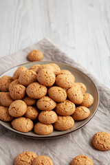 Homemade Italian Amaretti Cookie Biscuits on a Plate, side view. Copy space.
