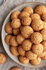 Homemade Italian Amaretti Cookie Biscuits on a Plate, top view. From above, overhead, flat lay. Close-up.