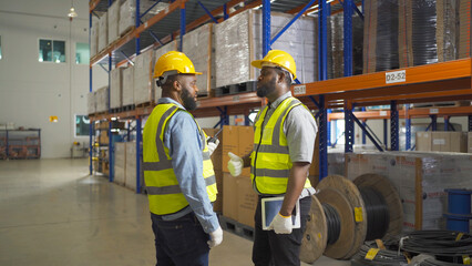 Teamwork of black workers working in large warehouse store industry.Rack of stock storage. Interior of cargo in ecommerce and logistic concept. Depot. People lifestyle. Shipment service for container