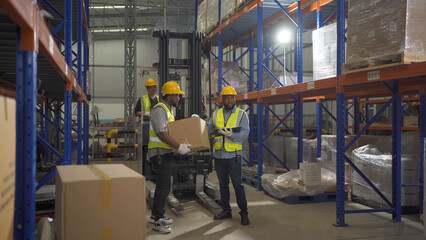 Teamwork of black workers working in large warehouse store industry.Rack of stock storage. Interior of cargo in ecommerce and logistic concept. Depot. People lifestyle. Shipment service for container