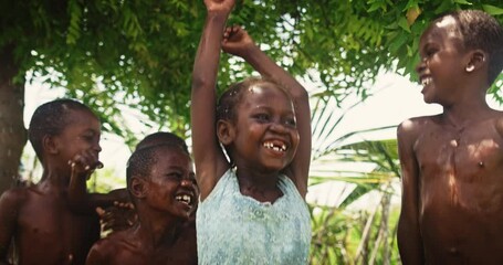 A Group Of African Children, Laughing and Playing with Water in Rural Area. Black Kids Enjoying and Appreciating the Gift of Water. Concept of Human Right to get Access to Clean Water Sources
