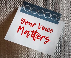 Note stick on wallpaper with text written YOUR VOICE MATTERS, concept of expressing one internal...