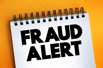Fraud Alert text on notepad, concept background