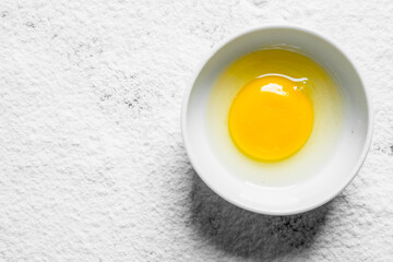 Fresh broken egg in bowl.