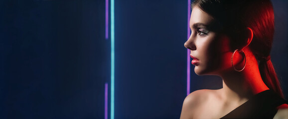 90s fashion. Neon beauty. Retro disco look. Red purple blue color light profile portrait of teen girl model face with party makeup on dark empty space background.