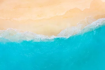 Fototapeten Summer seascape beautiful waves, blue sea water in sunny day. Top view from drone. Sea aerial view, amazing tropical nature background. Beautiful bright sea with waves splashing and beach sand concept © icemanphotos