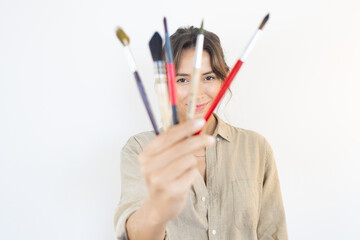 Happy woman with painting Brushes Choice Artist Creativity