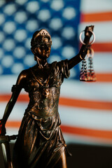 Lady justice statue with USA flag. Law symbols. Vertical image