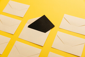 Opened paper envelope isolated over the yellow background