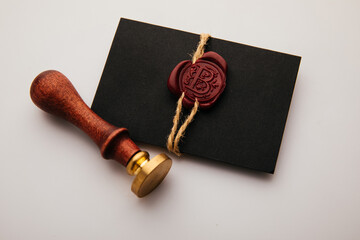 Notary public wax stamper. Black envelope with red wax seal and stamp close-up