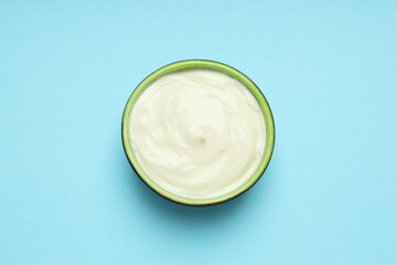 Concept of egg sauce, mayonnaise on blue background