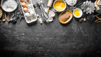 Baking background. Flour with cocoa, eggs and baking forms of the dough.