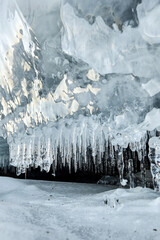 Blue ice cave.. The cave behind the ice curtains. icicles in a cave and a snowy mountain mountain nature ice snow. Ice cave. Selective focus.