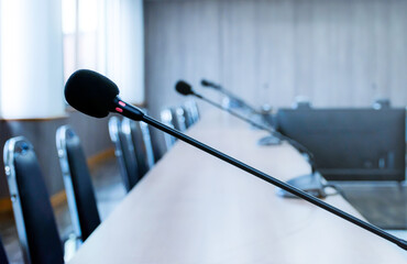 Close up microphone on brown table in meeting room