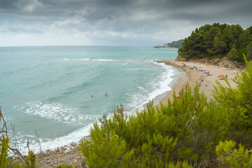 Tarragona Catalonia Spain   summer view of cala Torn nudist beach in a cloudy morning