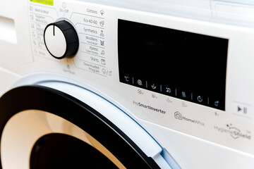 Domestic Display washing dryer machine. Macro photo part of modern home washing dryer machine dial.